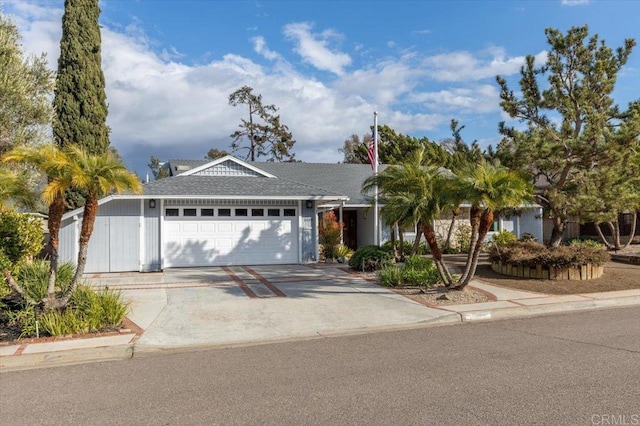 single story home featuring concrete driveway, an attached garage, and roof with shingles