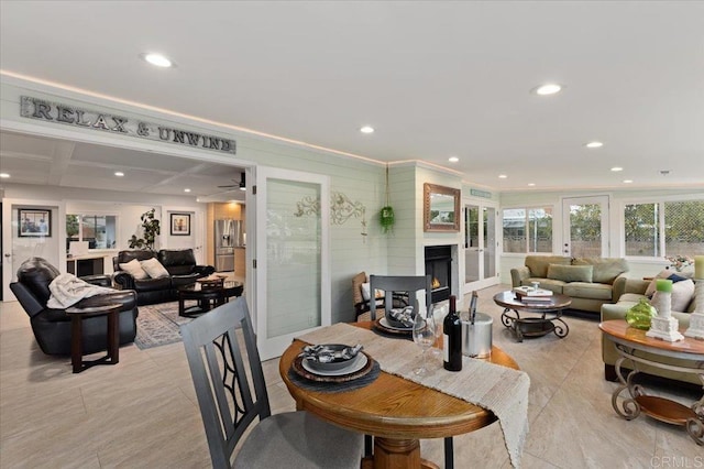 living room featuring recessed lighting and a lit fireplace