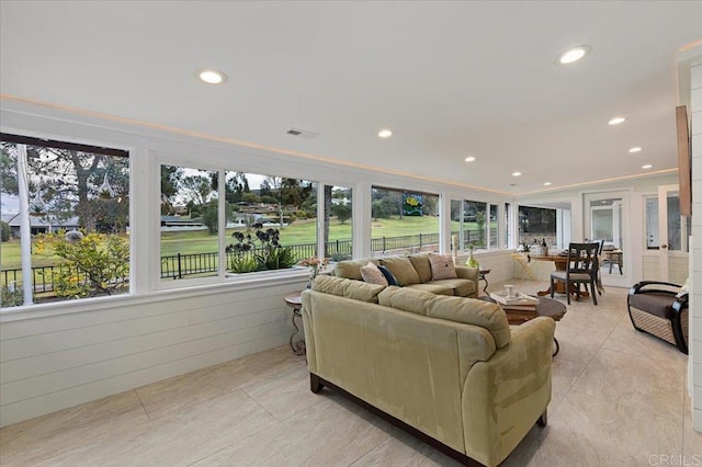 living area featuring visible vents, recessed lighting, and ornamental molding