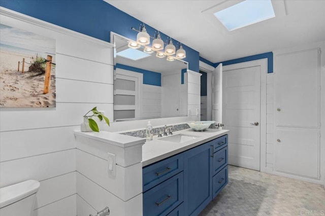 bathroom featuring toilet and vanity