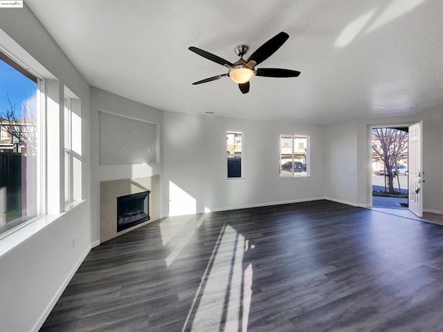 unfurnished living room with dark wood-type flooring and ceiling fan