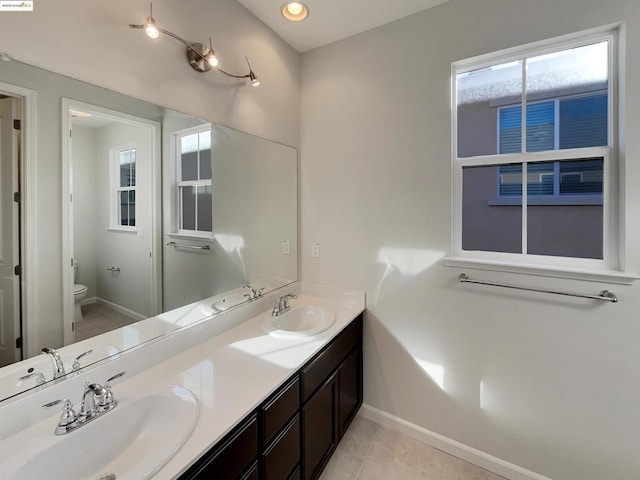 bathroom with tile patterned floors, toilet, and vanity