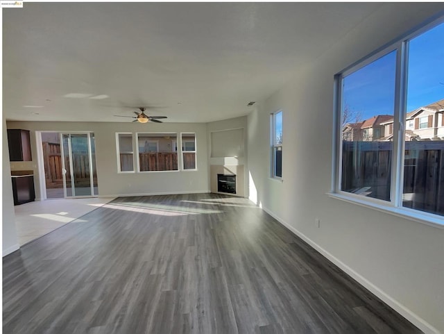 unfurnished living room with hardwood / wood-style floors and ceiling fan