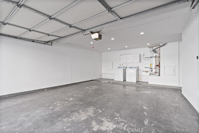 garage featuring baseboards, washer and clothes dryer, a garage door opener, secured water heater, and recessed lighting