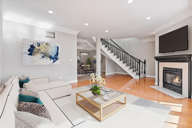 living room with recessed lighting, crown molding, stairway, and wood finished floors