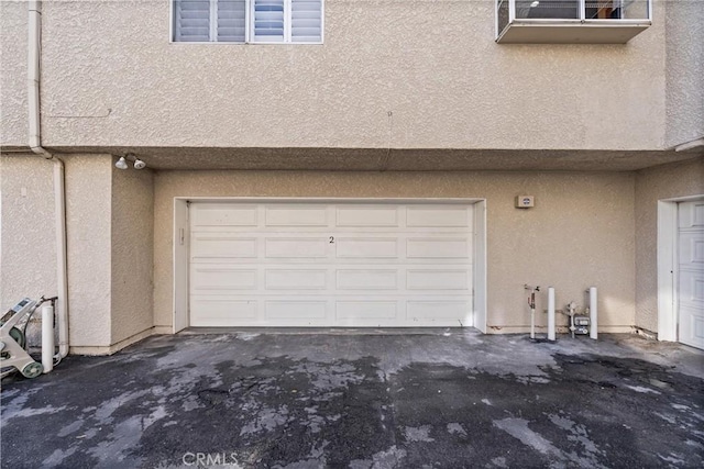 garage featuring aphalt driveway