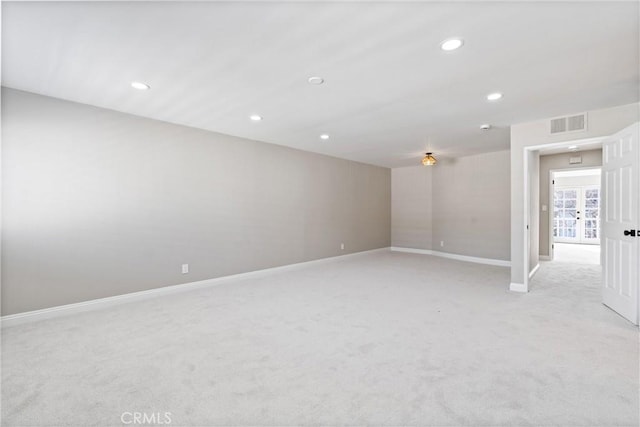 unfurnished room featuring light carpet, baseboards, visible vents, and recessed lighting