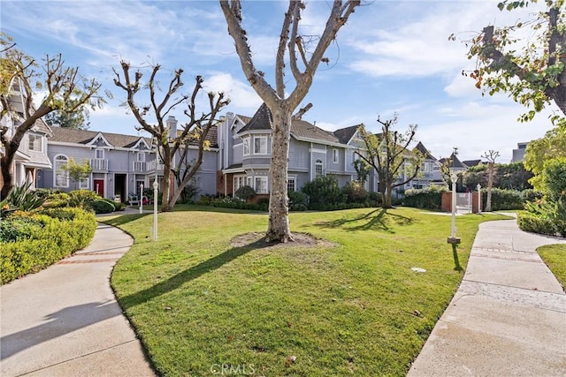 view of property's community with a lawn and a residential view