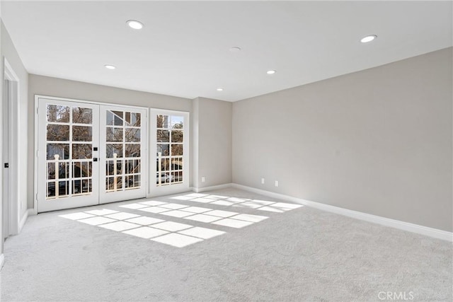 spare room with carpet floors, recessed lighting, baseboards, and french doors