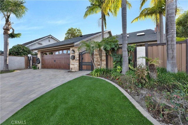 view of front of house with a garage and a front lawn