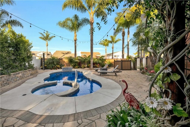 view of swimming pool with an in ground hot tub and a patio