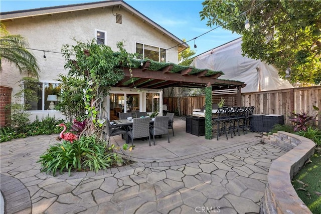 view of patio / terrace featuring exterior bar and a pergola