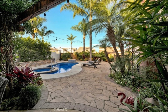 view of pool featuring a patio area and an in ground hot tub