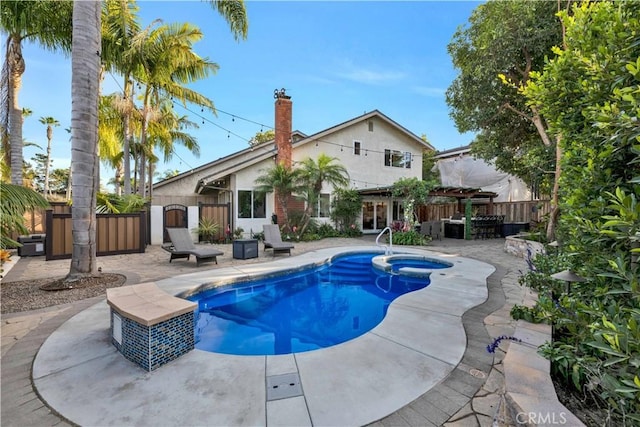 view of pool with a pergola, a patio, and an in ground hot tub