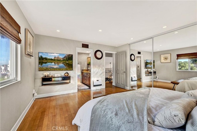 bedroom featuring hardwood / wood-style floors, a closet, and ensuite bathroom