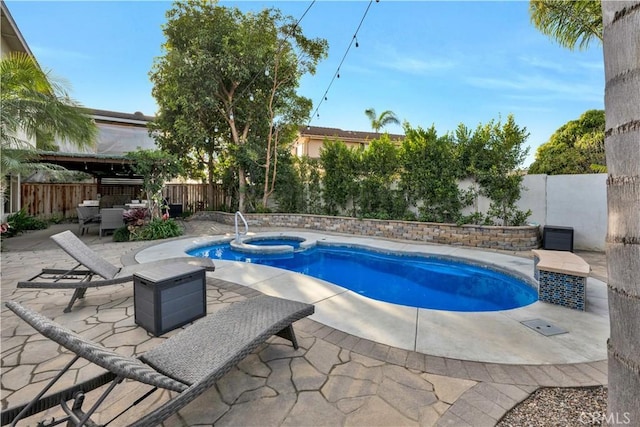 view of pool featuring a patio area and an in ground hot tub