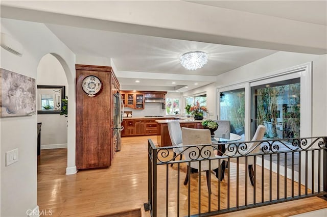 dining area with a chandelier and light hardwood / wood-style flooring