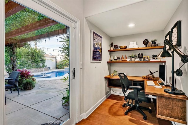 home office with hardwood / wood-style floors