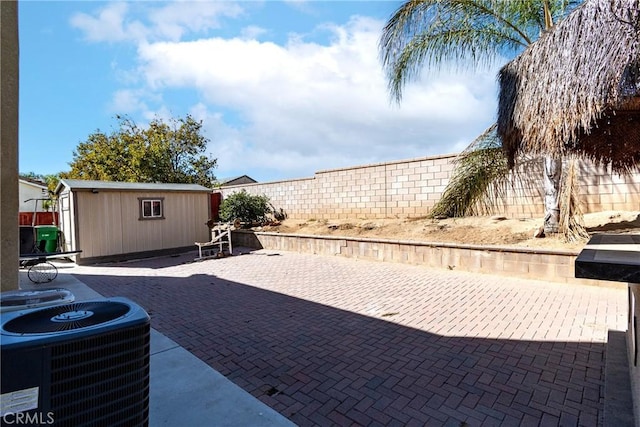 view of patio / terrace with a storage shed and central air condition unit