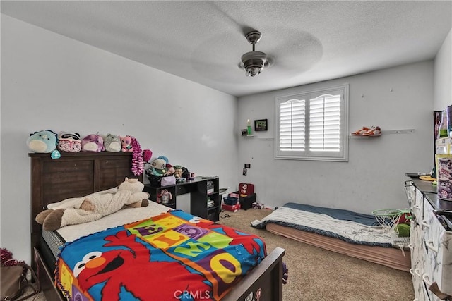 bedroom with a textured ceiling, ceiling fan, and carpet