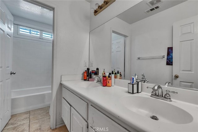 bathroom with tile patterned flooring, vanity, and shower / bath combination