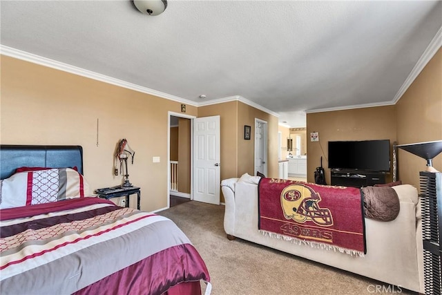 bedroom featuring ornamental molding, ensuite bathroom, and carpet flooring