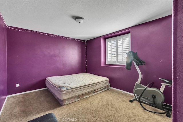 bedroom with carpet flooring and a textured ceiling