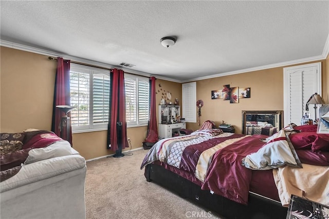 bedroom with crown molding, carpet floors, and a textured ceiling