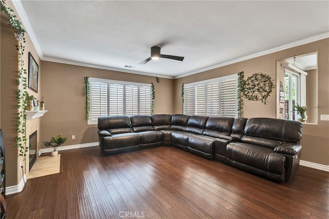 living room featuring ceiling fan, ornamental molding, dark hardwood / wood-style floors, and a high end fireplace