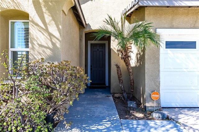 doorway to property with a garage