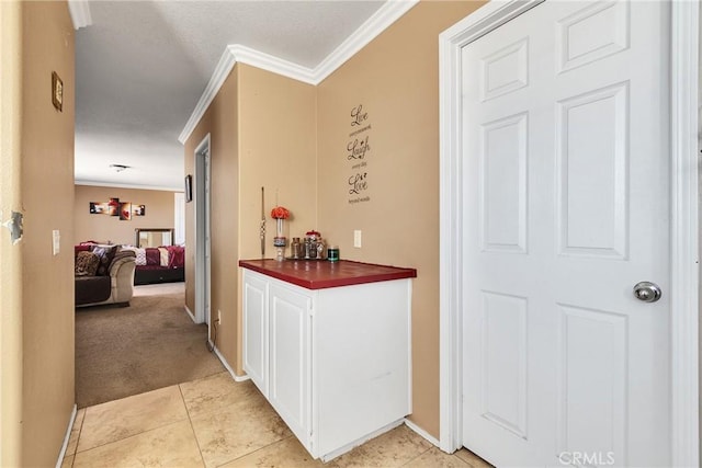 hall featuring light carpet and crown molding