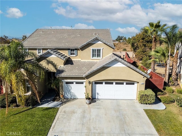 view of front of home featuring a garage and a front lawn