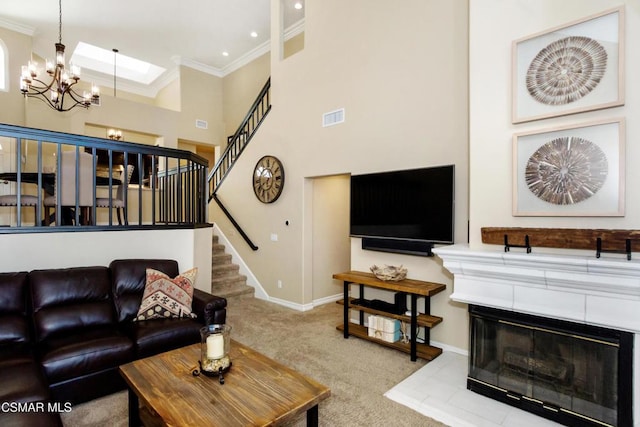 living room with light carpet, crown molding, a chandelier, and a towering ceiling