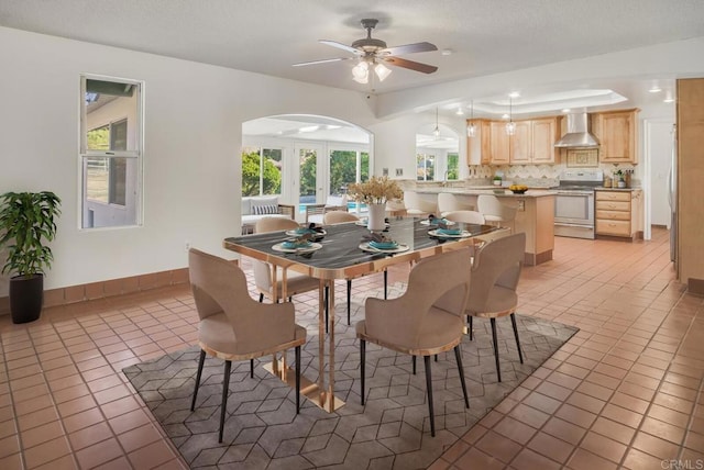 tiled dining space featuring ceiling fan