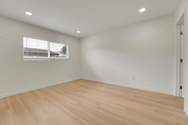 spare room featuring light hardwood / wood-style floors