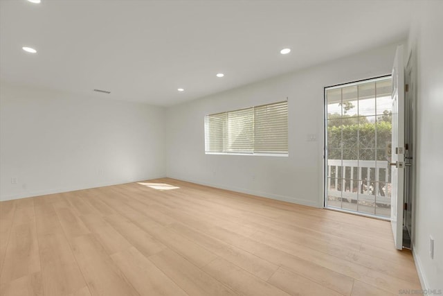 empty room with light hardwood / wood-style floors