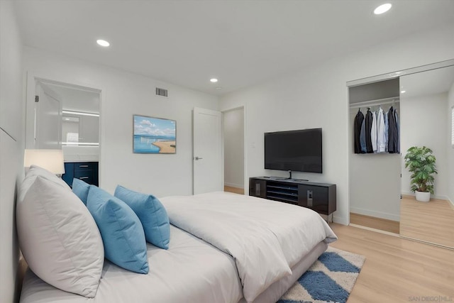 bedroom featuring light hardwood / wood-style floors and a closet