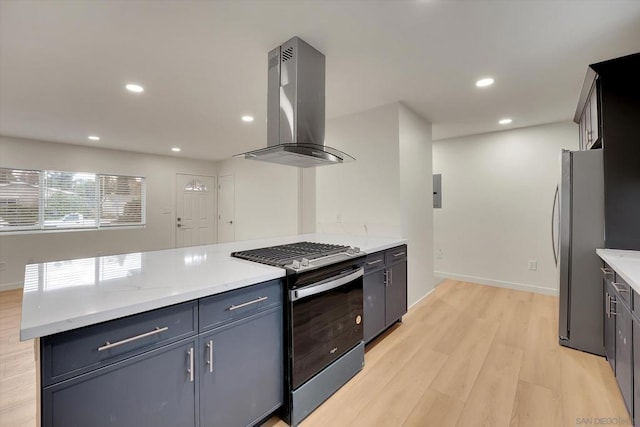 kitchen featuring light stone counters, island range hood, stainless steel appliances, and light wood-type flooring