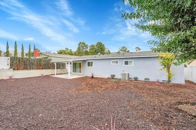 back of property with cooling unit and a patio area