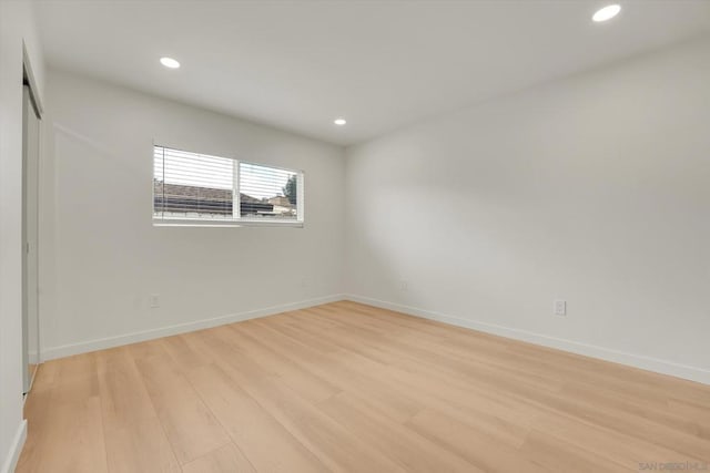 spare room with light hardwood / wood-style floors