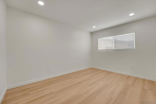 spare room featuring light hardwood / wood-style flooring