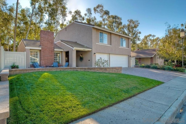 view of front property featuring a garage and a front lawn