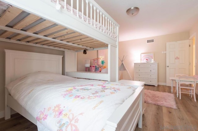 bedroom with hardwood / wood-style flooring