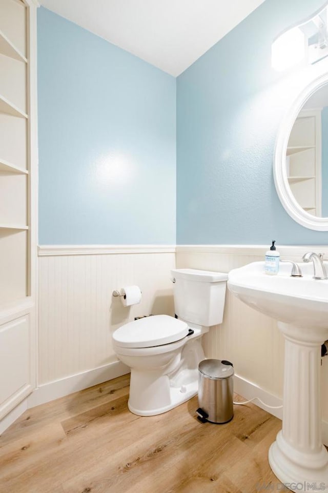 bathroom featuring hardwood / wood-style flooring and toilet