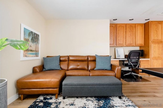 living room with light hardwood / wood-style flooring and built in desk