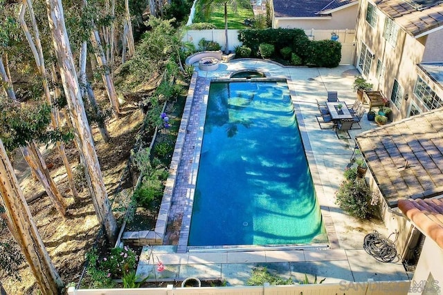 view of pool with an in ground hot tub and a patio