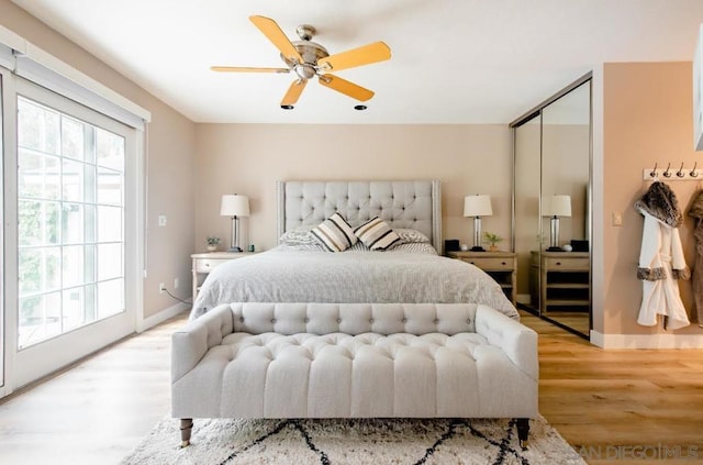 bedroom with a closet, ceiling fan, and light wood-type flooring