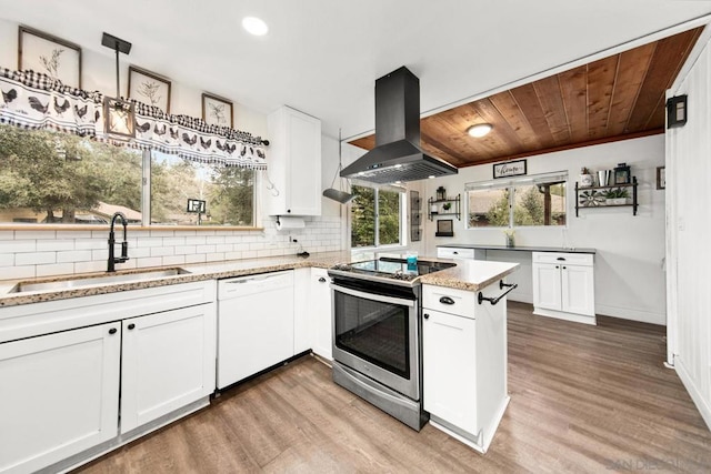 kitchen with dishwasher, sink, white cabinets, stainless steel range with electric stovetop, and island exhaust hood