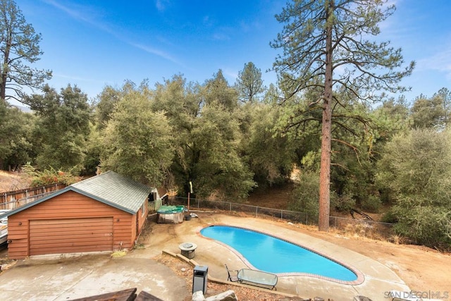 view of pool with an outbuilding and a garage