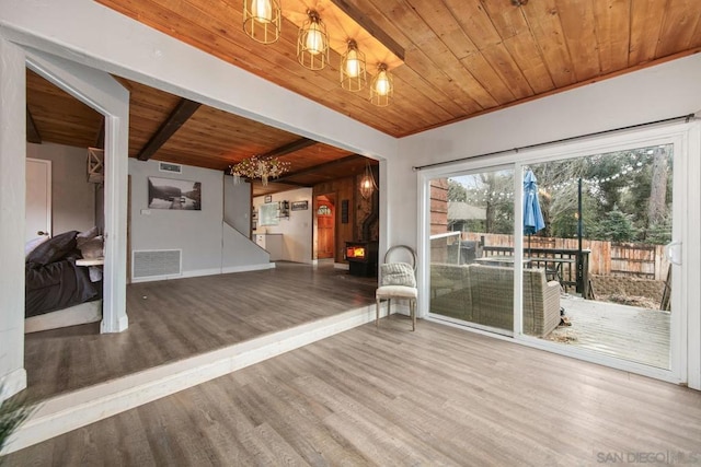 interior space with hardwood / wood-style flooring, wooden ceiling, and beam ceiling